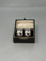 Load image into Gallery viewer, A pair of Antique Sterling Silver Napkin Rings in original box
